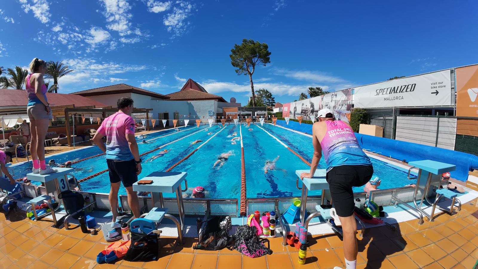 TTT coaches at an outdoor training pool in Mallorca